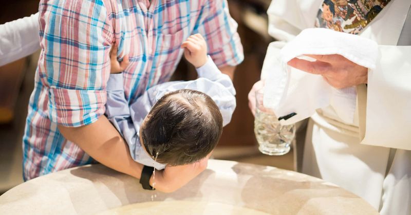 Puta! Puta! Potty-mouthed toddler's rant at priest during baptism goes viral