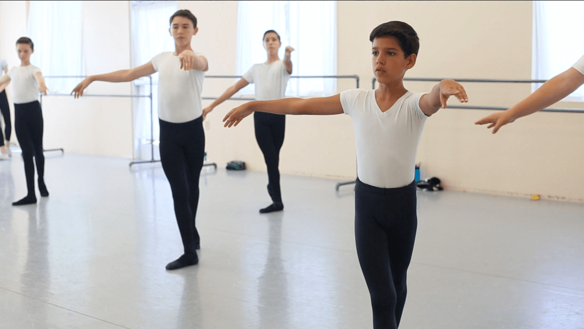 A still from the documentary Danseur shows young boys during a ballet class.