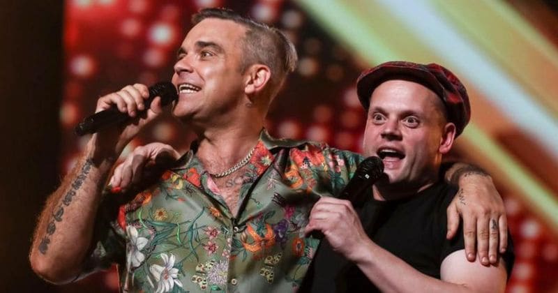X Factor judge Robbie Williams makes a fan's dream come true by joining him on stage to sing 'Angels'