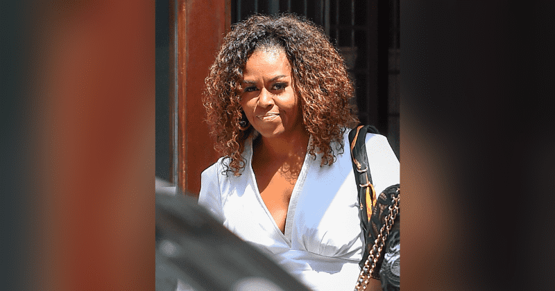 Michelle Obama stuns in natural curls, elegant white dress as she walks into Robert De Niro's New York hotel for luncheon