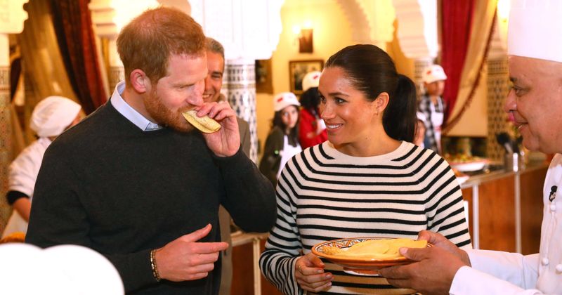 A TASTE OF ROYALTY: Meghan Markle is all smiles as she rolls up her sleeves and cooks with Grenfell Tower victims