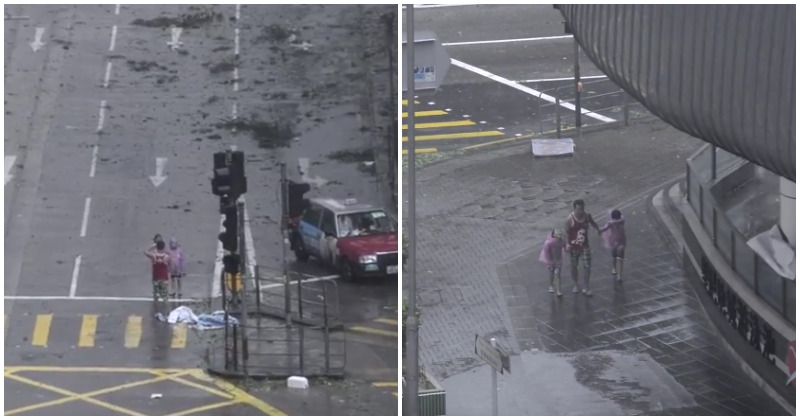 Irresponsible dad orders his two children to pose for photos during deadly 140 mph typhoon