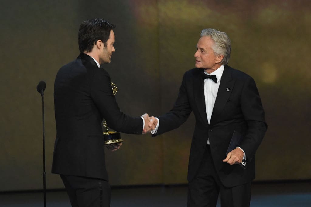 Bill Hader (L) accepts the Outstanding Lead Actor in a Comedy Series award for 'Barry' from Michael Douglas onstage during the 70th Emmy Awards at Microsoft Theater on September 17, 2018 in Los Angeles, California. (Photo by Kevin Winter/Getty Images)
