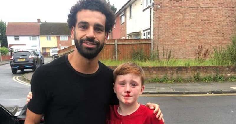 Liverpool forward Mohamed Salah comes back for photo with young fan who bust his nose while running behind his soccer star's car