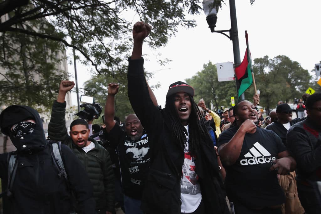 Activists celebrate outside the Leighton Criminal Courts Building after hearing the verdict in the murder trial of Chicago police officer Jason Van Dyke on October 5, 2018 in Chicago, Illinois. (Photo by Scott Olson/Getty Images)