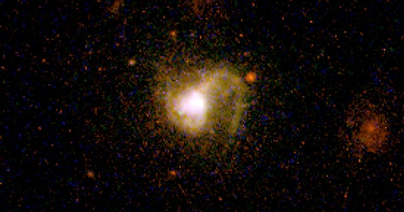 Scientists observe dwarf galaxy churning out its first stars 9.4 billion years ago using giant galaxy cluster as magnifying lens