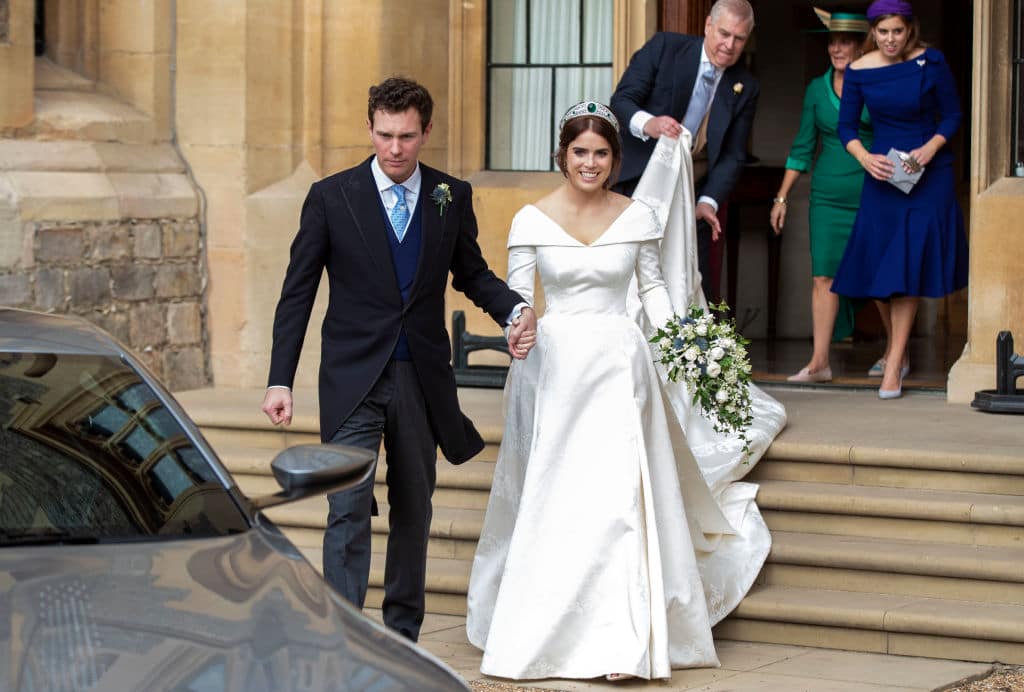 Princess Eugenie and Jack Brooksbank helped by Princess Beatrice and Prince Andrew, Duke of York leave Windsor Castle in an Aston Martin DB10 after their wedding for an evening reception at Royal Lodge on October 12, 2018 in Windsor, England (Getty Images)