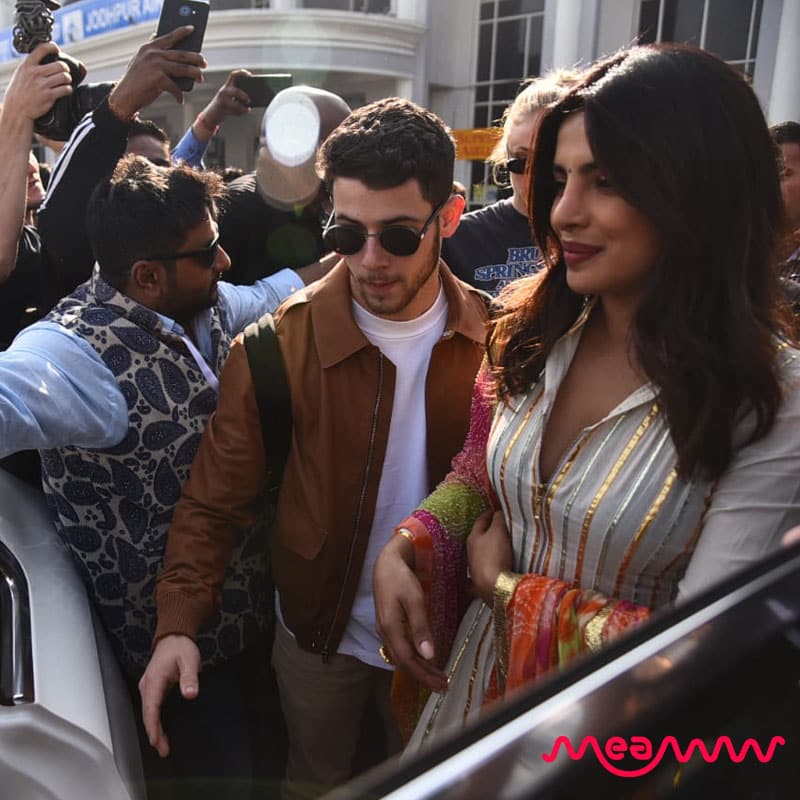 Dressed in a striped white kurti and palazzo paired with a colorful dupatta, the bride-to-be was all smiles as she was spotted with her beau at the Jodhpur airport in India (Meaww Photo)