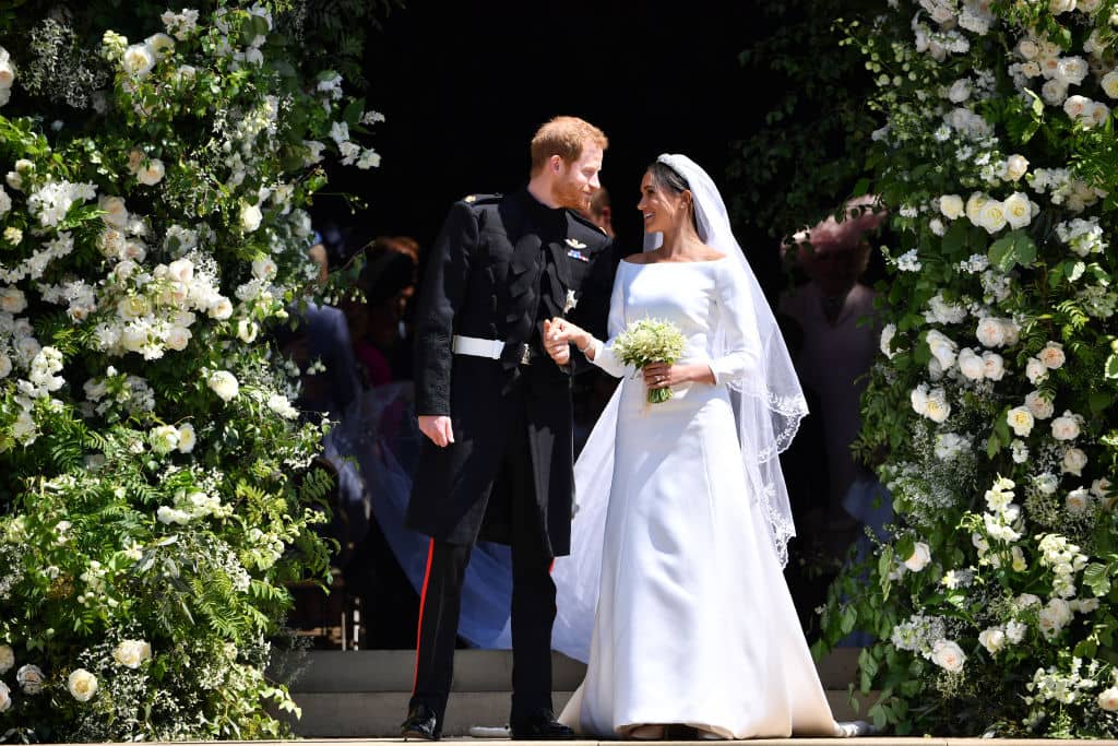 Britain's Prince Harry, Duke of Sussex and his wife Meghan, Duchess of Sussex leave from the West Door of St George's Chapel, Windsor Castle, in Windsor on May 19, 2018 in Windsor, England. (Photo by Ben STANSALL - WPA Pool/Getty Images)