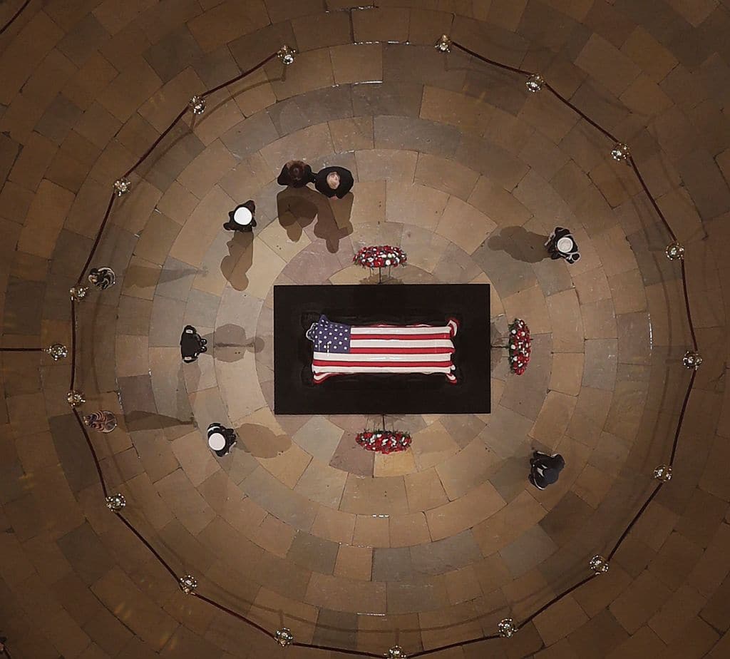 Donald Trump and Melania Trump pay their respects to Former President George H. W. Bush as he lies in state in the U.S. Capitol Rotunda on December 03, 2018 in Washington, DC. A WWII combat veteran, Bush served as a member of Congress from Texas, ambassador to the United Nations, director of the CIA, vice president and 41st president of the United States. A state funeral for Bush will be held in Washington over the next three days, beginning with him lying in state in the U.S. Capitol Rotunda until Wednesday morning. (Photo by Morry Gash - Pool/Getty Images)