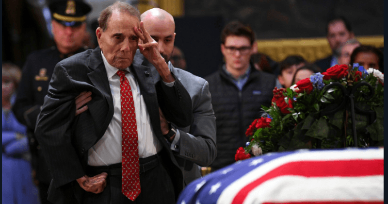 Former senator Bob Dole, 95, rises from his wheelchair for one final emotional salute to George HW Bush