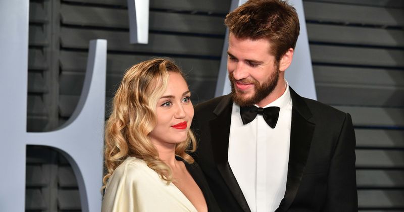 Miley Cyrus dazzles in first wedding portrait alongside parents Tish and Billy Ray after exchanging vows with Liam Hemsworth