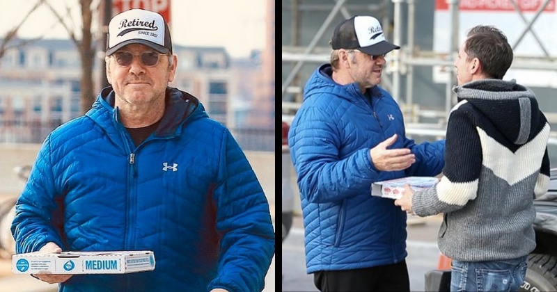Kevin Spacey delivers pizzas to paparazzi while sporting a hat that reads 'Retired since 2017'