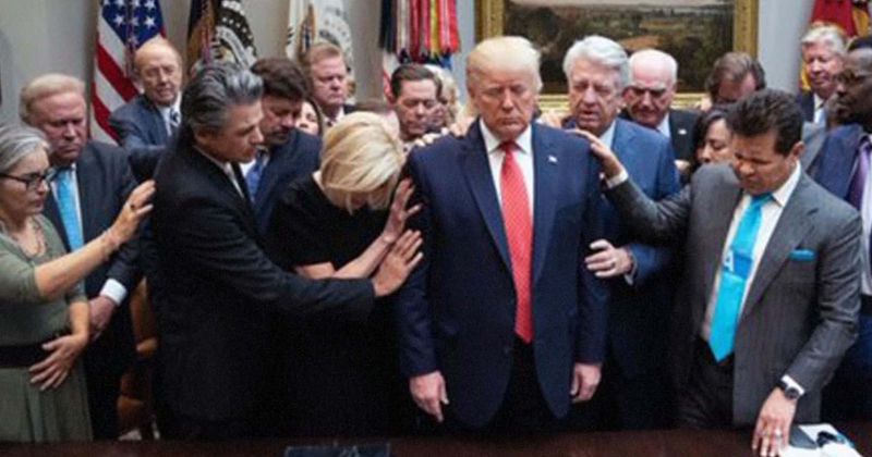 Evangelical leaders lay hands on Trump and pray for him as impeachment inquiry gathers steam