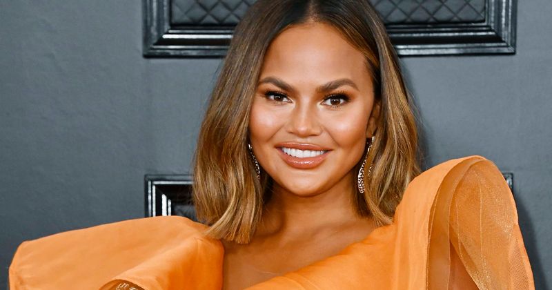 Chrissy Teigen vows not to be 'such an a**hole' after fans slam her for 'tone-deaf' tweet about mom's spending habits