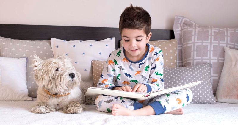 Do dogs help children develop? New study finds having a pooch in the room helps kids spend more time reading and learning