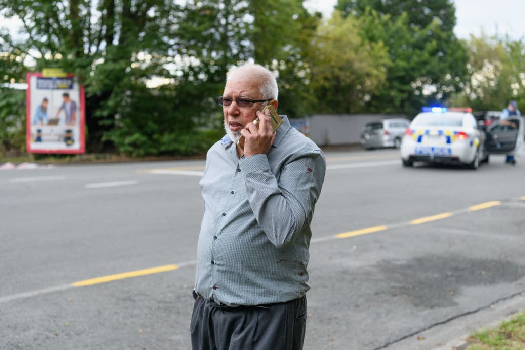 Ramzan Ali, thought to be the last man to get out of the Masjd Al Noor Mosque alive, waits in front of the mosque as he waits for news about his brother who was with him in the mosque on March 15, 2019 in Christchurch, New Zealand. Armed police are at second mosque in suburb of Linwood. The number of casualties and fatalities has yet to be confirmed. Streets near the mosques have been evacuated, and schools and businesses around the city are now in lock down . (Photo by Kai Schwoerer/Getty Images)