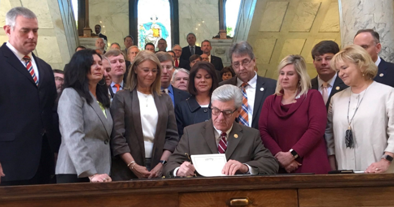 Mississippi governor bans abortions at about six weeks if 'heartbeat' can be heard