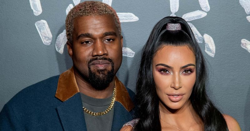 Kanye West's 'crazy' pose in Kim Kardashian's New Year post of the celebs sharing a kiss leaves fans confused
