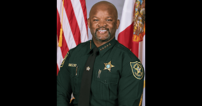 Florida sheriff seen half-naked with topless women at erotic party had killed man when he was JUST 14 years old
