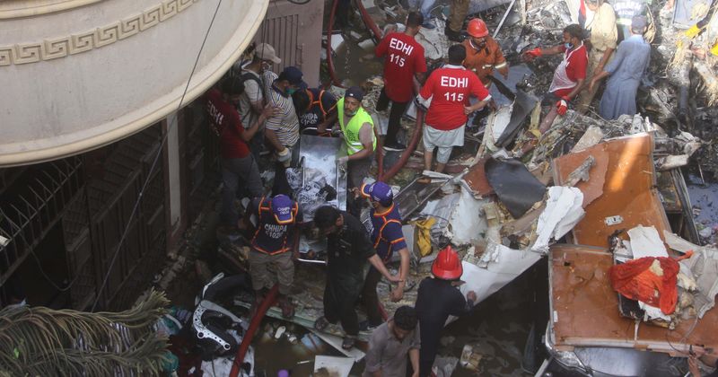 Incredible moment a baby is rescued from wreckage on live TV after plane crashed into residential area in Pakistan