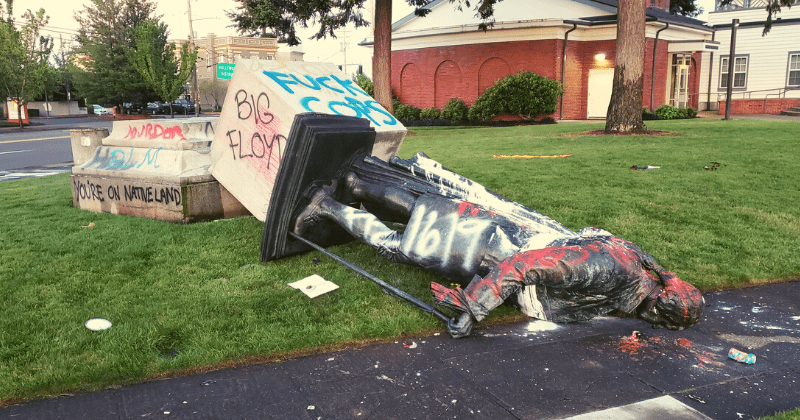 Statue of George Washington toppled and wrapped in burning US flag during George Floyd protest in Portland