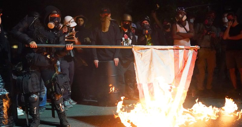 Portland protesters burn Bible, American flag outside courthouse amid increasing clashes with federal agents