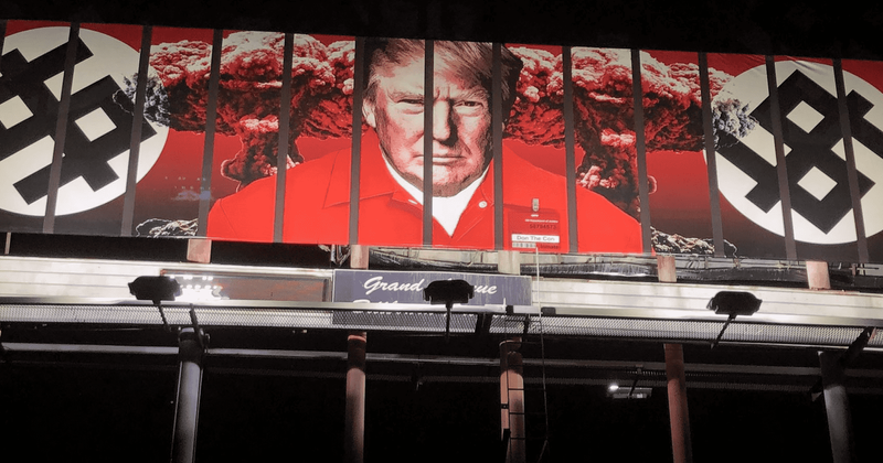 Donald Trump shown wearing orange prison jumpsuit behind bars on Arizona billboard that calls him 'Don the Con'