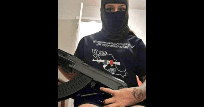 Who is ‘The Demon’? Chilling photo of female assassin posing with AK-47 and sporting a huge tattoo goes viral
